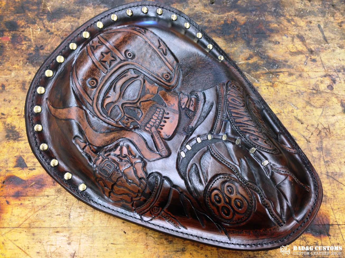 We’re proud to showcase a custom-made seat and saddlebags set crafted specifically for Doug Wothke, the legendary round-the-world motorcycle traveler. Made from hand-tooled and antiqued veg-tan leather, this set took countless hours of expert craftsmanship to complete. Designed for both durability and vintage authenticity, it will accompany him on the 2014 Cannonball Motorcycle Race, as he tackles this grueling challenge aboard his classic Harley-Davidson JD motorcycle. A true tribute to adventure!