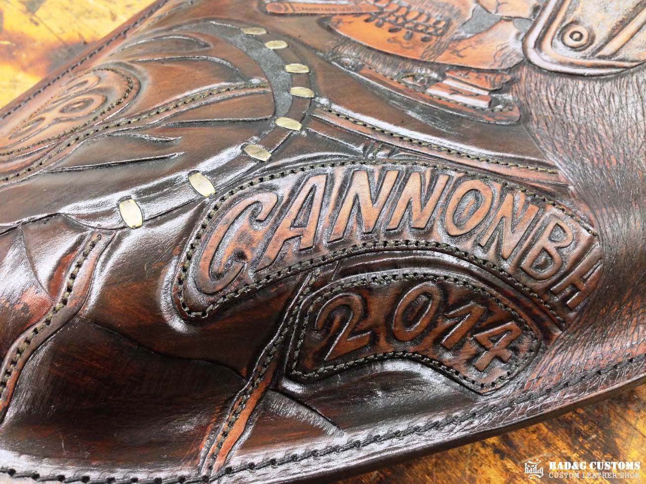 We’re proud to showcase a custom-made seat and saddlebags set crafted specifically for Doug Wothke, the legendary round-the-world motorcycle traveler. Made from hand-tooled and antiqued veg-tan leather, this set took countless hours of expert craftsmanship to complete. Designed for both durability and vintage authenticity, it will accompany him on the 2014 Cannonball Motorcycle Race, as he tackles this grueling challenge aboard his classic Harley-Davidson JD motorcycle. A true tribute to adventure!