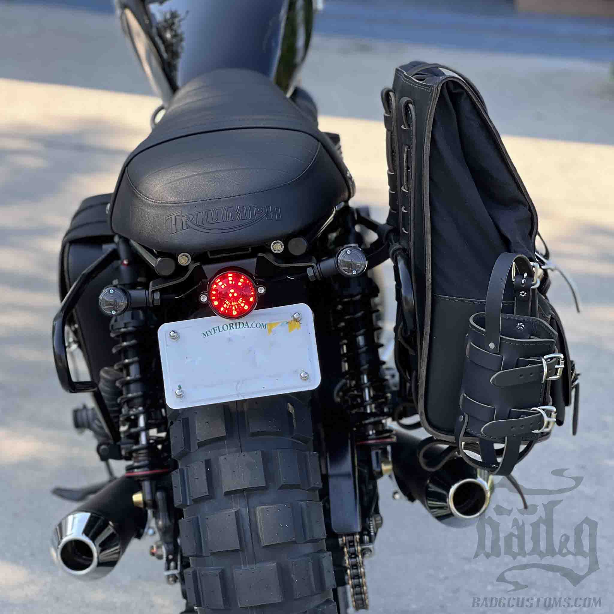 Upgrade your ride with the URB03 Rolltop Backpack Saddlebag. Unique design enables quick conversion from saddlebag to backpack. Hand crafted in USA with premium veg tan water buffalo leather, waxed canvas and stainless steel hardware. Durable and stylish, it's the perfect fit for your motorcycle.